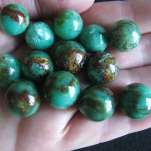 $36-42 each IMG6094 - Chrysoprase Spheres Brilliant Brown markings 5 x 14mm round 18.4cts to 3 x 16mm round 29.6cts 8 remaining 14mm $36 each / 16mm $42 each
