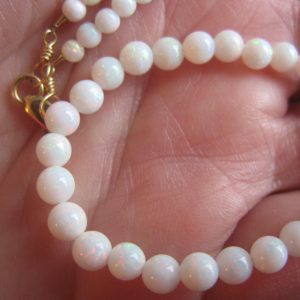 $3,300 IMG5975 - Mintubi Gem Reds - some Greens "skin to skin" 4-5mm Round bead Strand with gold clasp 40cts