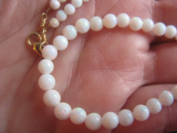 $3,300 IMG5975 - Mintubi Gem Reds - some Greens "skin to skin" 4-5mm Round bead Strand with gold clasp 40cts