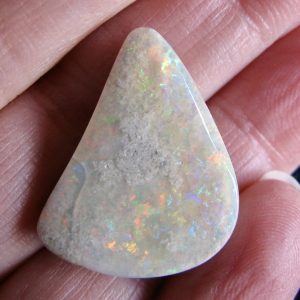 Mintubi Bright Reds, Golds, Blues and Greens on Sandstone small crack on side $12/ct 19.3cts